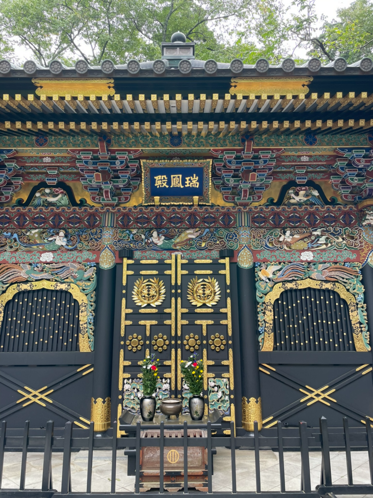 Zuihoden Mausoleum in Sendai, featuring colourful traditional decorations surrounded by trees. 